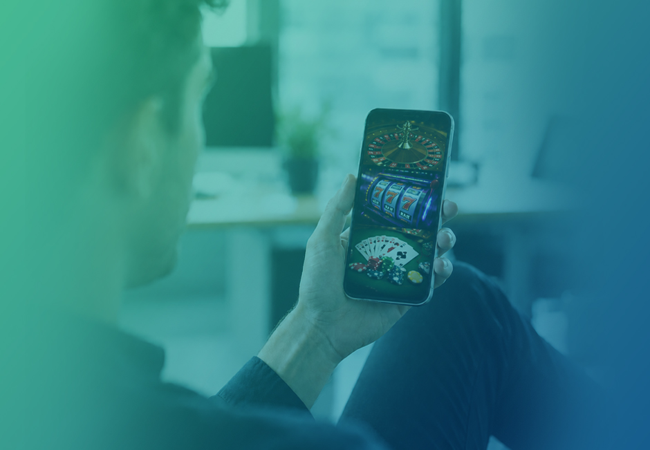 A Man Seen from Behind Holding a Phone with Gambling Ads on the Screen