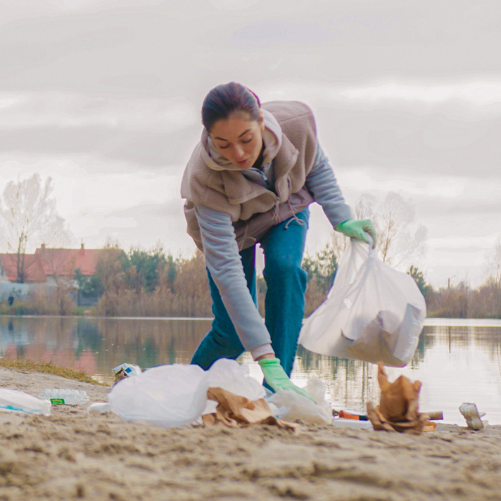 iGamingCare Employee Participating in a World Cleanup Day Event by Clearing Litter from a Beach