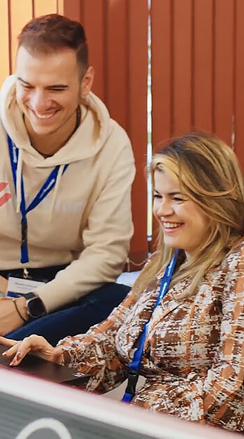 Two iGaming.com Colleagues Smiling and Collaborating at the Office