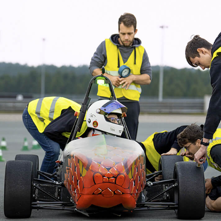 Students and Team Members Working on a Formula Student Car at HSMW, Sponsored by iGaming.com