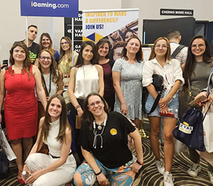 iGaming.com Team Posing for a Group Photo at a Conference