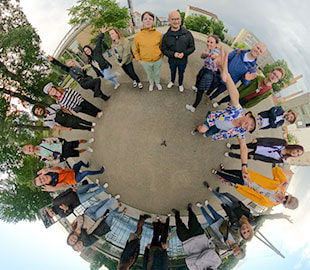 iGaming.com Team Posing in a Circular Formation Outdoors