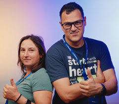 Two iGaming.com Employees Giving Thumbs Up